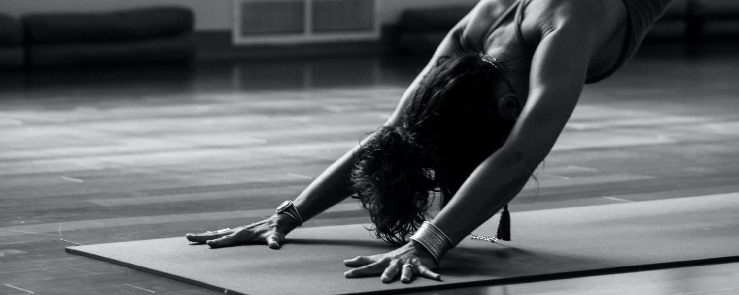 a woman in Downward Dog Pose